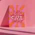Retro-style poster with psychedelic 1970s-inspired design. Text reads "WEIRD GIRLS DO IT BETTER" in wavy, groovy lettering. Pink and orange sunburst background. Centered text surrounded by curved rays. Bold red frame with scalloped edges. Vibrant colors and playful typography create a vintage hippie vibe. Square format print with rounded corners. Perfect for fans of retro aesthetics and empowering slogans.